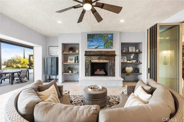 41783 Valencia Way, Temecula, CA 92592 - living room with built in features, a ceiling fan, a premium fireplace, and recessed lighting