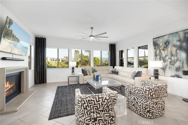 41783 Valencia Way, Temecula, CA 92592 - tiled living room featuring healthy amount of natural light, ceiling fan, and a glass covered fireplace