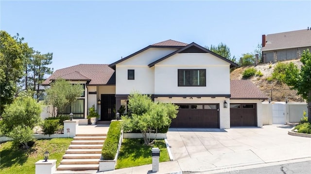 2056 Dublin Dr, Glendale, CA 91206 - view of front of home featuring concrete driveway, a gate, stucco siding, stairway, and brick siding