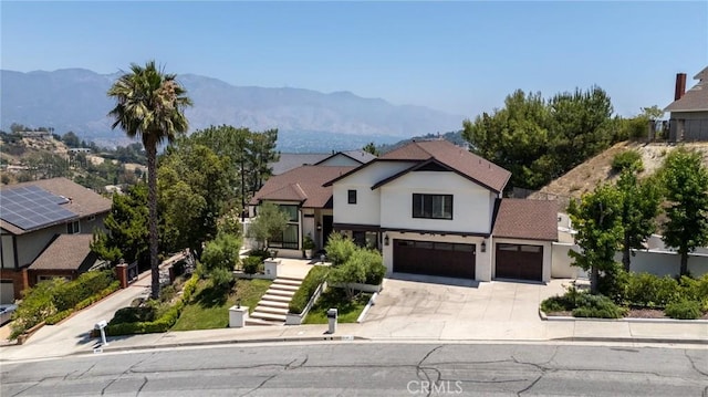 2056 Dublin Dr, Glendale, CA 91206 - view of front of home featuring concrete driveway, a garage, stucco siding, and a mountain view