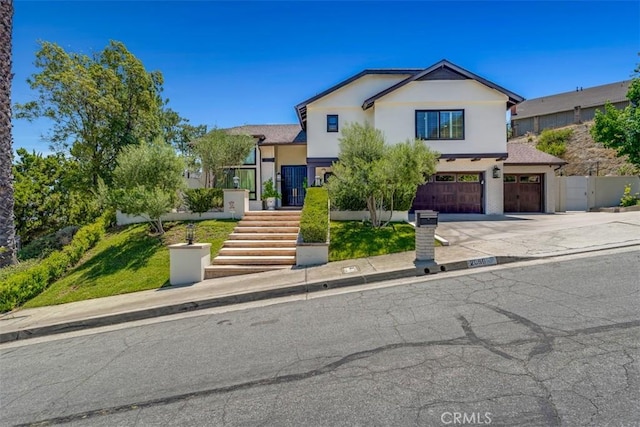 2056 Dublin Dr, Glendale, CA 91206 - view of front of house featuring driveway, stucco siding, and an attached garage