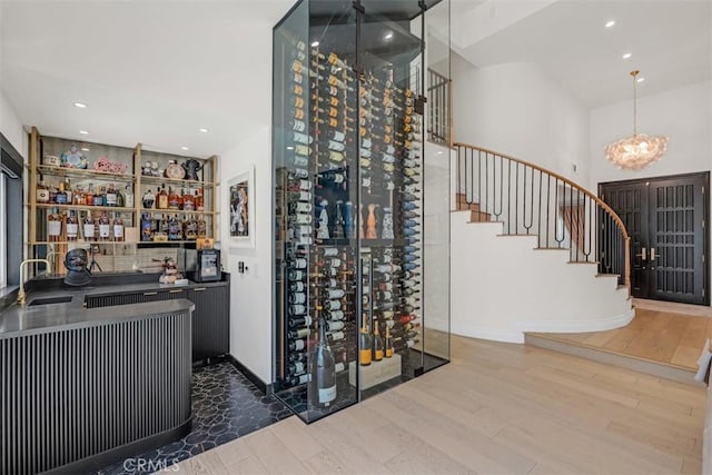 2056 Dublin Dr, Glendale, CA 91206 - wine area with wood finished floors, wet bar, a chandelier, and recessed lighting