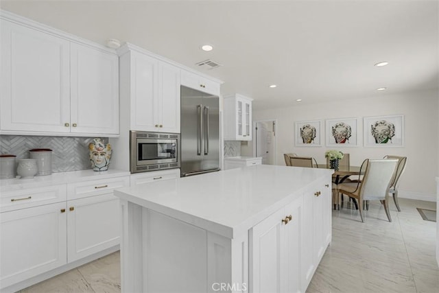 2056 Dublin Dr, Glendale, CA 91206 - kitchen featuring built in appliances, white cabinets, light countertops, recessed lighting, and backsplash