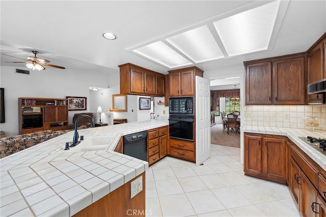 16151 Sunset Way, Valley Center, CA 92082 - kitchen featuring black appliances, tile countertops, light tile patterned flooring, ceiling fan, and tasteful backsplash