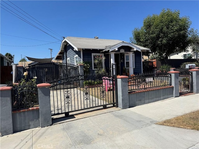 825 E Eagle St, Long Beach, CA 90806 - view of front of house featuring a fenced front yard, a gate, and a shingled roof