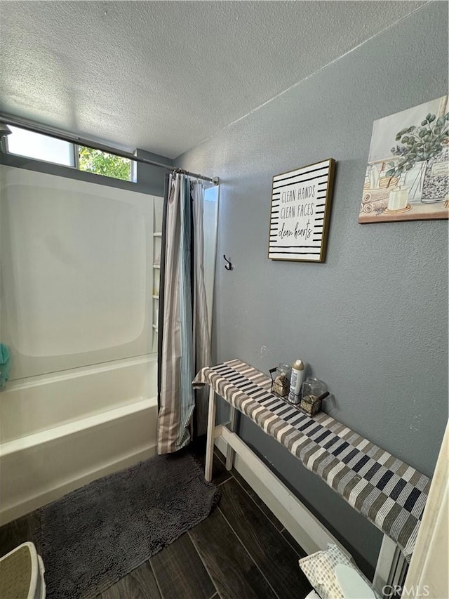 825 E Eagle St, Long Beach, CA 90806 - full bathroom featuring shower / tub combo with curtain, wood finished floors, and a textured ceiling