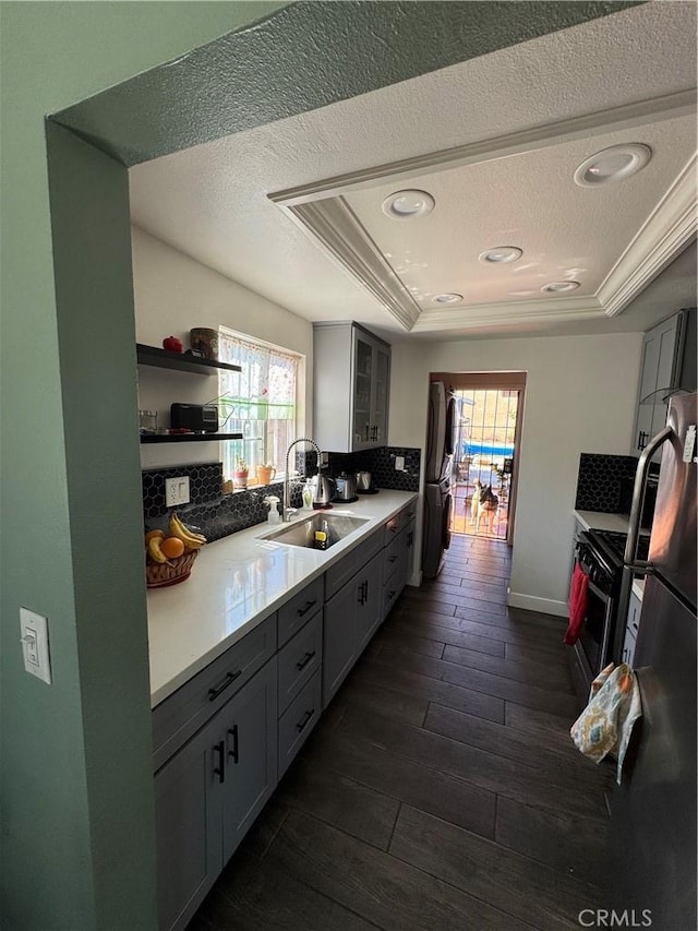 825 E Eagle St, Long Beach, CA 90806 - kitchen featuring a tray ceiling, plenty of natural light, decorative backsplash, a textured ceiling, and dark wood finished floors