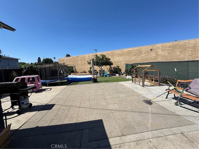 825 E Eagle St, Long Beach, CA 90806 - fenced backyard with a trampoline and a patio