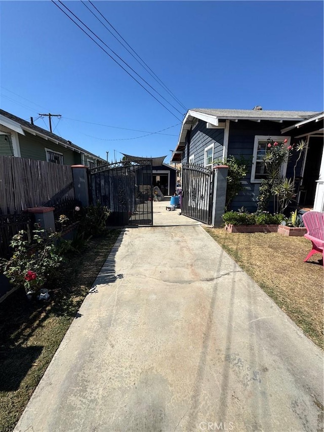 825 E Eagle St, Long Beach, CA 90806 - view of property exterior featuring concrete driveway and a gate