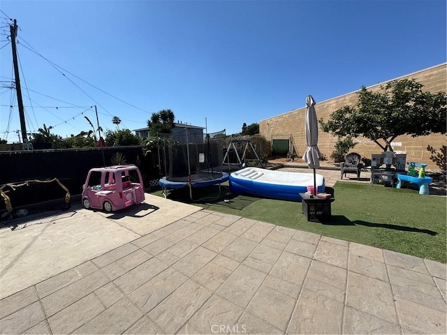 825 E Eagle St, Long Beach, CA 90806 - fenced backyard featuring a patio area and a trampoline
