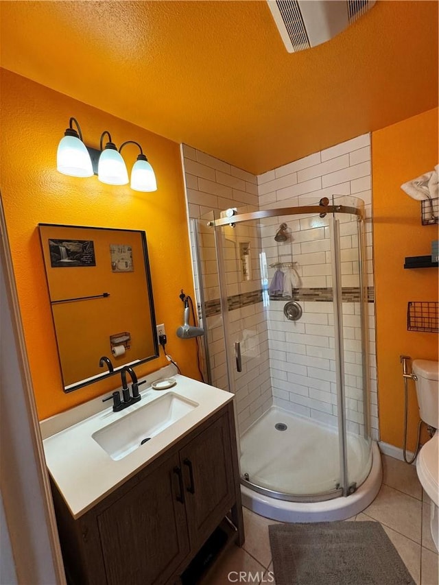 825 E Eagle St, Long Beach, CA 90806 - full bathroom featuring a stall shower, vanity, tile patterned floors, and a textured ceiling
