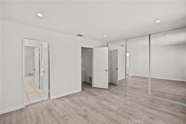 1495 Mccabe Way, West Covina, CA 91791 - unfurnished bedroom featuring wood finished floors, a closet, recessed lighting, and ensuite bath