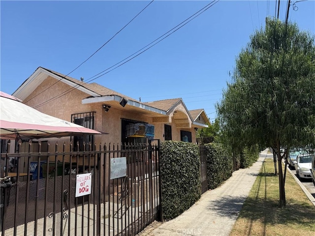 1569 E 109th St, Los Angeles, CA 90059 - view of front of property with a fenced front yard, stucco siding, and a gate