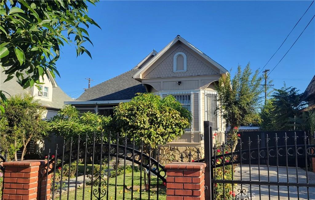 207 E 25th St, Los Angeles, CA 90011 - victorian home with roof with shingles and a gate
