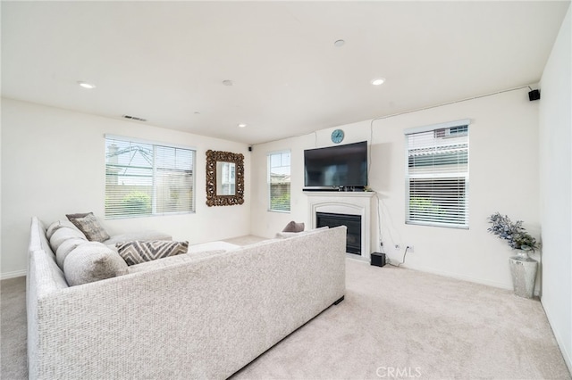 13243 Stanton Dr, Rancho Cucamonga, CA 91739 - living area with light carpet, a glass covered fireplace, and recessed lighting