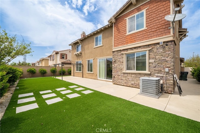 13243 Stanton Dr, Rancho Cucamonga, CA 91739 - back of house with stone siding, a fenced backyard, a patio area, and a chimney
