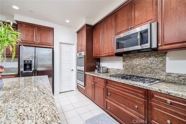 13243 Stanton Dr, Rancho Cucamonga, CA 91739 - kitchen with appliances with stainless steel finishes, light tile patterned floors, backsplash, light stone countertops, and recessed lighting