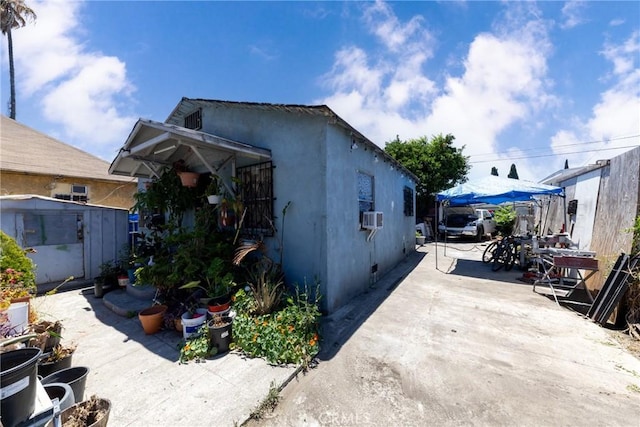 1684 E Martin Luther King Jr Blvd, Los Angeles, CA 90011 - view of front facade featuring a patio area, stucco siding, and driveway
