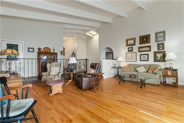 750 Luisita St, Morro Bay, CA 93442 - living area featuring light wood-type flooring, beamed ceiling, arched walkways, and high vaulted ceiling