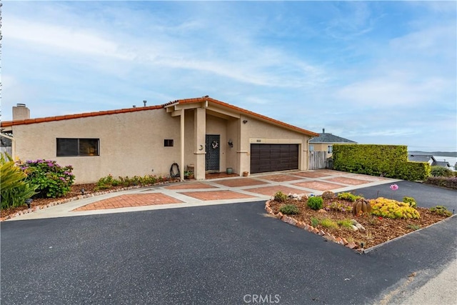 750 Luisita St, Morro Bay, CA 93442 - view of front facade with a garage, stucco siding, concrete driveway, and a chimney