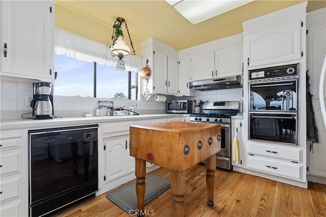 750 Luisita St, Morro Bay, CA 93442 - kitchen featuring black appliances, under cabinet range hood, tasteful backsplash, and white cabinets