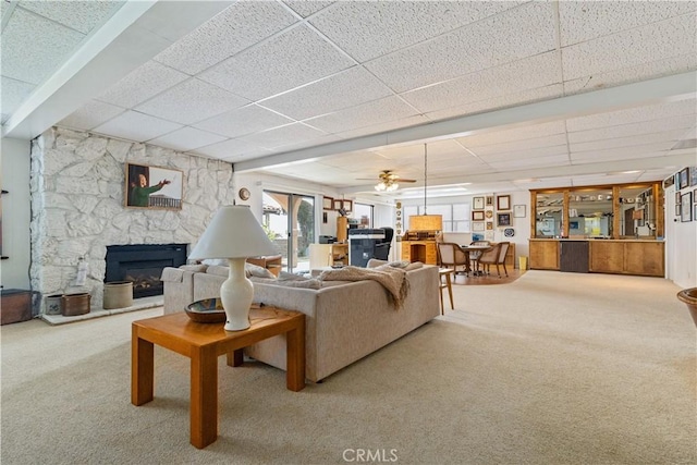 750 Luisita St, Morro Bay, CA 93442 - living room featuring carpet floors, a drop ceiling, a fireplace, and a ceiling fan