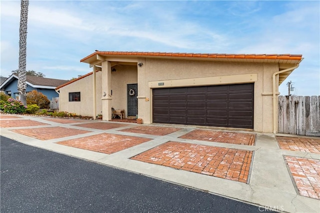 750 Luisita St, Morro Bay, CA 93442 - view of front of home featuring stucco siding, decorative driveway, and an attached garage