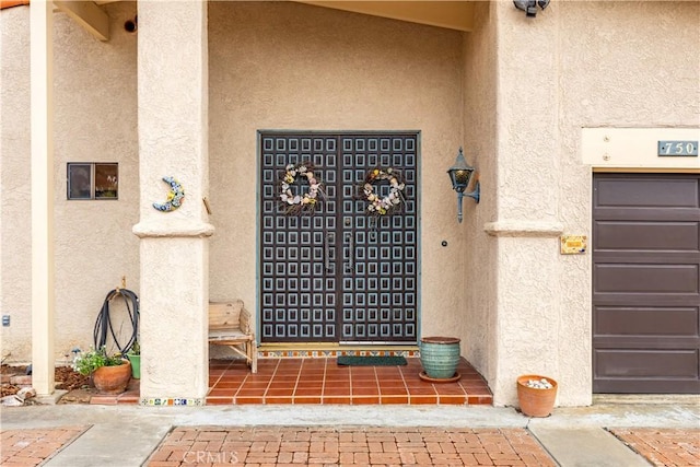 750 Luisita St, Morro Bay, CA 93442 - doorway to property with stucco siding and a garage