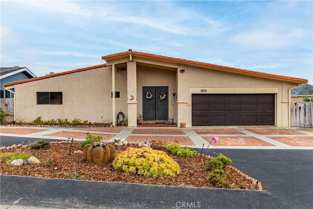 750 Luisita St, Morro Bay, CA 93442 - view of front facade featuring stucco siding, a garage, and driveway
