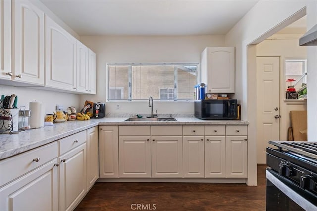 228 S 4th St, Santa Paula, CA 93060 - kitchen featuring black appliances, white cabinetry, light stone counters, and dark wood-style floors