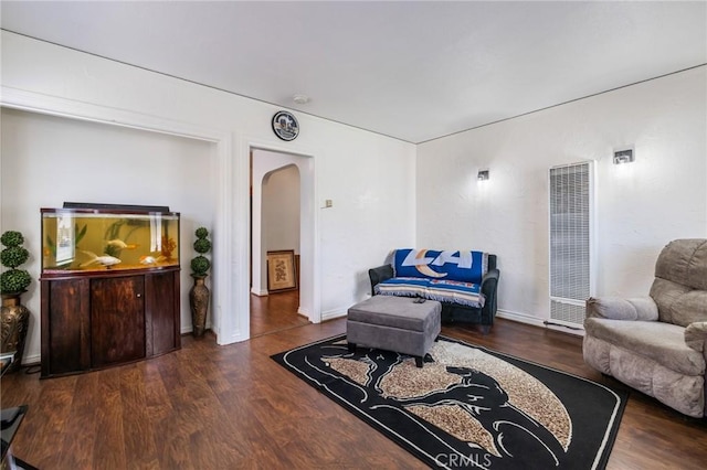 228 S 4th St, Santa Paula, CA 93060 - living area with a heating unit, arched walkways, and wood finished floors