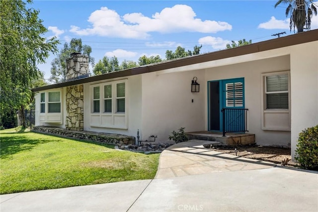 1296 Tiger Tail Dr, Riverside, CA 92506 - doorway to property featuring a chimney, a yard, and stucco siding