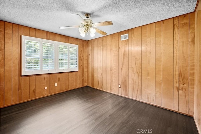 1296 Tiger Tail Dr, Riverside, CA 92506 - spare room featuring wood finished floors, a ceiling fan, wooden walls, and a textured ceiling