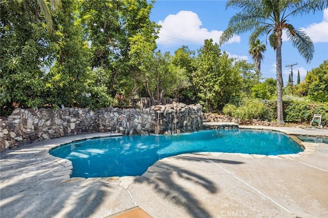 1296 Tiger Tail Dr, Riverside, CA 92506 - view of pool with a patio area, a pool with connected hot tub, and view of wooded area