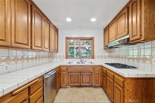 1296 Tiger Tail Dr, Riverside, CA 92506 - kitchen with appliances with stainless steel finishes, brown cabinets, backsplash, recessed lighting, and light tile patterned floors