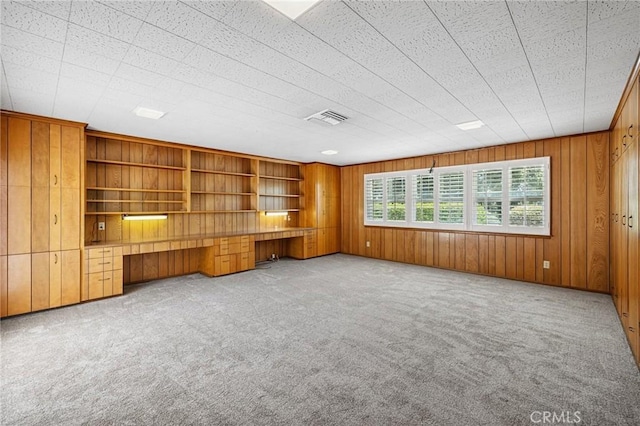 1296 Tiger Tail Dr, Riverside, CA 92506 - unfurnished office with built in desk, carpet flooring, wooden walls, and built in shelves