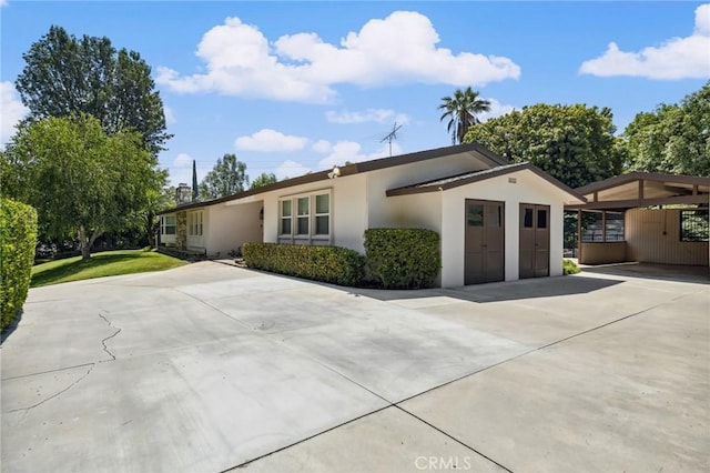 1296 Tiger Tail Dr, Riverside, CA 92506 - view of front of house with stucco siding and driveway