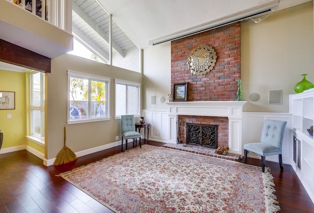 23402 Devonshire Dr, Lake Forest, CA 92630 - living area featuring a fireplace, dark wood finished floors, wainscoting, and a decorative wall