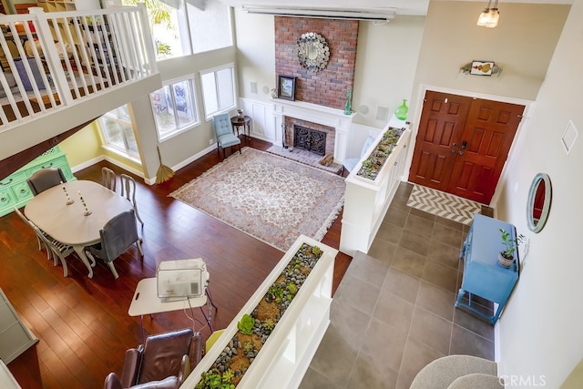 23402 Devonshire Dr, Lake Forest, CA 92630 - living area featuring a brick fireplace, wood finished floors, and a towering ceiling