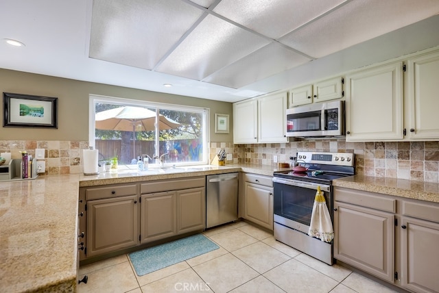 23402 Devonshire Dr, Lake Forest, CA 92630 - kitchen with appliances with stainless steel finishes, tile counters, backsplash, light tile patterned floors, and recessed lighting