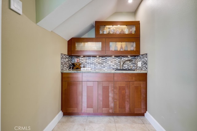 23402 Devonshire Dr, Lake Forest, CA 92630 - bar area featuring decorative backsplash, vaulted ceiling, and light tile patterned floors