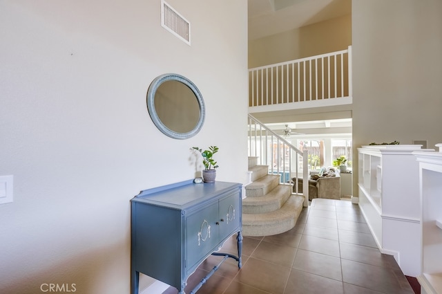 23402 Devonshire Dr, Lake Forest, CA 92630 - hall with tile patterned flooring, a high ceiling, and stairs