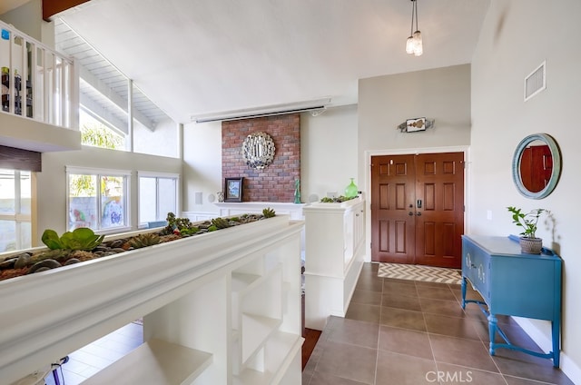 23402 Devonshire Dr, Lake Forest, CA 92630 - entrance foyer featuring a towering ceiling and dark tile patterned floors