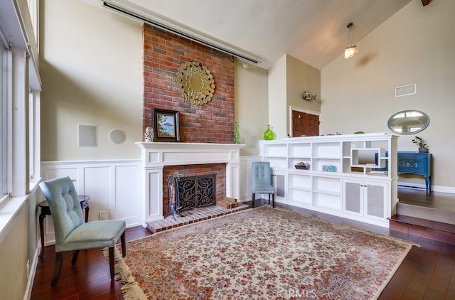 23402 Devonshire Dr, Lake Forest, CA 92630 - living room featuring hardwood / wood-style floors, a fireplace, a wainscoted wall, high vaulted ceiling, and a decorative wall