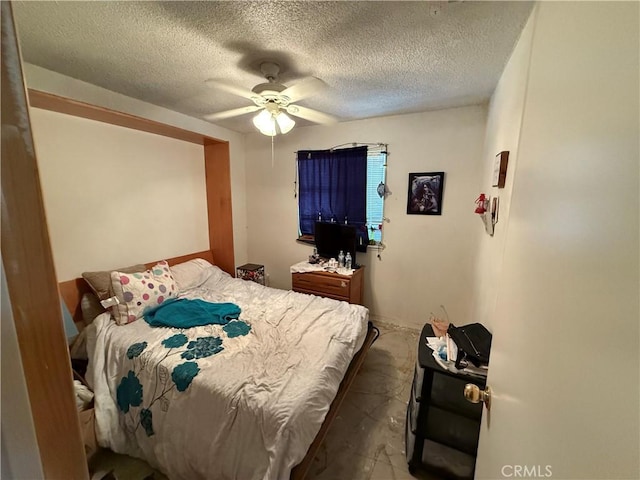 5320 Jonah St, Bakersfield, CA 93307 - bedroom featuring a textured ceiling, ceiling fan, and concrete flooring