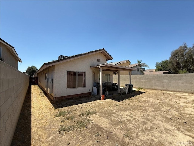5320 Jonah St, Bakersfield, CA 93307 - rear view of house with a fenced backyard and stucco siding