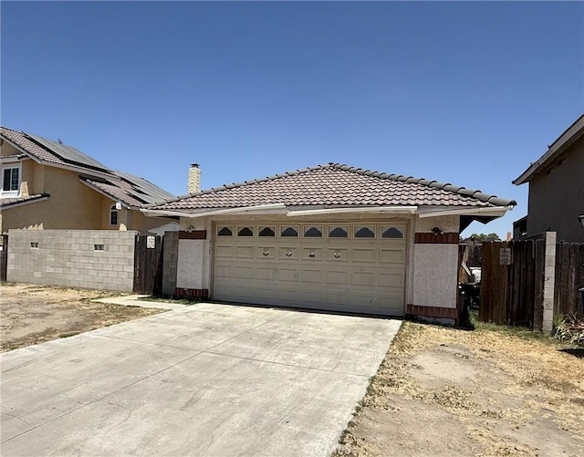 5320 Jonah St, Bakersfield, CA 93307 - view of front of home featuring a tile roof, concrete driveway, a gate, and an attached garage