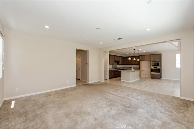 16123 Apricot Ave, Chino, CA 91708 - unfurnished living room with light colored carpet and recessed lighting