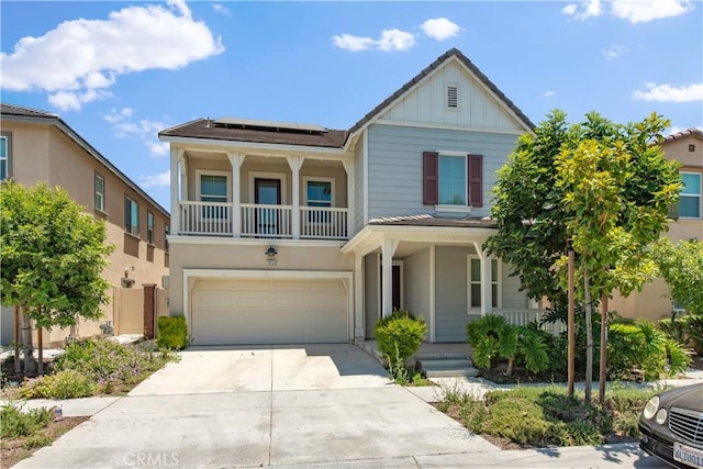 16123 Apricot Ave, Chino, CA 91708 - view of front of property featuring a porch, solar panels, driveway, board and batten siding, and an attached garage