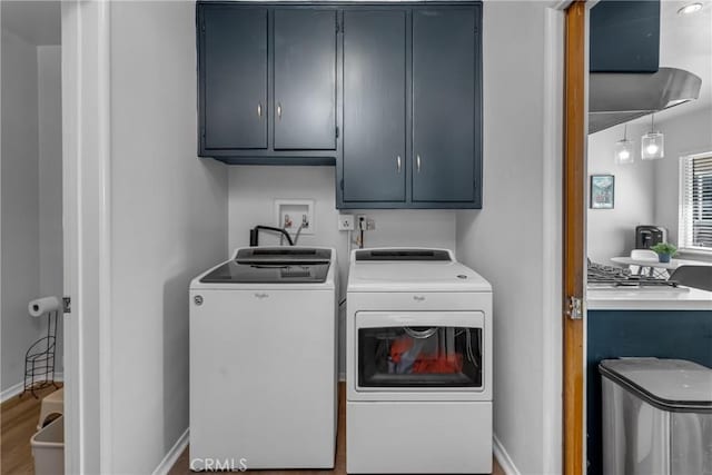 9811 Kempster Ave, Fontana, CA 92335 - laundry area featuring cabinet space, washer and dryer, and wood finished floors